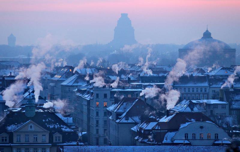 Smoking chimneys can be seen on early February 6, 2012 in Leipzig, eastern Germany, where temperatures fell down to minus 20 degrees Celsius. The deadly cold snap that has gripped Europe for more than a week wrought more havoc across the continent, straining emergency services, grounding flights and pushing the death toll past 300.  AFP PHOTO / JAN WOITAS    GERMANY OUT
 *** Local Caption ***  807533-01-08.jpg