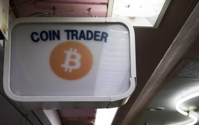 Signage is displayed outside the Coin Trader bitcoin retail store in Tokyo, Japan, on Wednesday, Aug. 30, 2017. Stock of Bitcoin, the best-known digital currency, has surged 358 percent this year. While staggering, lesser-known competitors have seen even bigger gains, such as the more than 4,000 percent increase for ethereum. Photographer: Tomohiro Ohsumi/Bloomberg