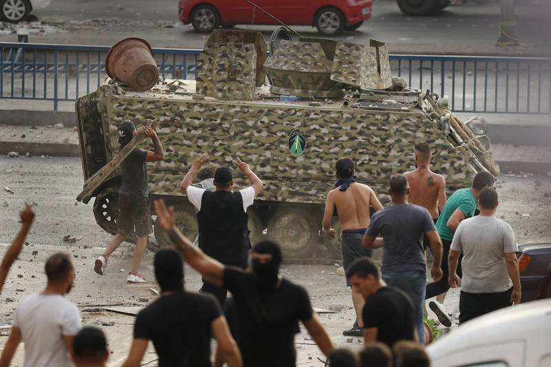 An armoured vehicle is attacked by supporters of Saad Hariri. Some protesters said they were partly venting their anger at the country's economic crisis.