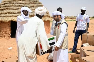 The UAE humanitarian team based in Amdjarass distributes food parcels to Sudanese refugees in the village of Herakaia, Chad. Wam