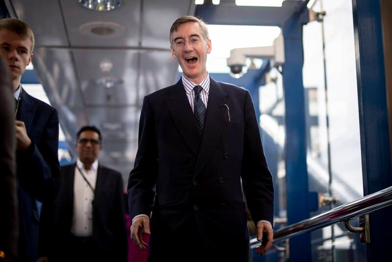 Business, Energy and Industrial Strategy Secretary Jacob Rees-Mogg laughs as he arrives. EPA