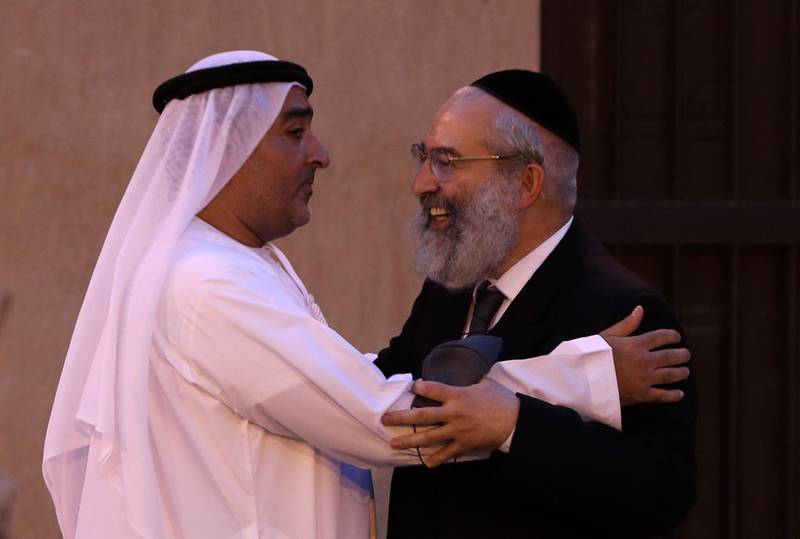 Ahmed Al Mansoori, founder of Crossroads of Civilisation Museum, left, greets a rabbi at the exhibition opening. AP Photo