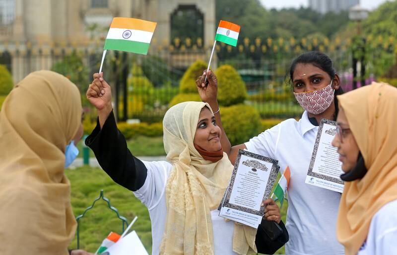 Students wave Indian flags in front of the Vidhana Soudha, seat of the State Legislature of Karnataka, during celebrations in Bangalore. EPA