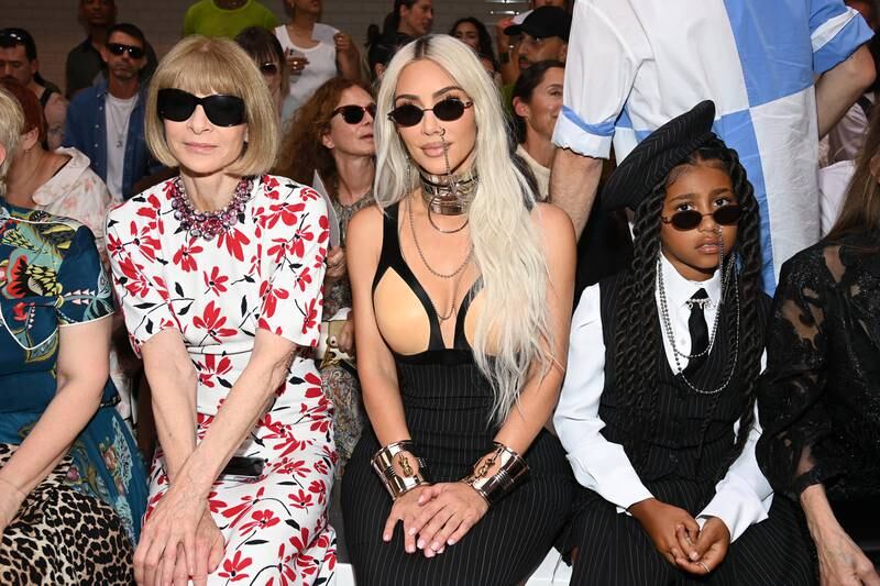 Kim Kardashian sits front row with 'Vogue' head Anna Wintour, left. Getty