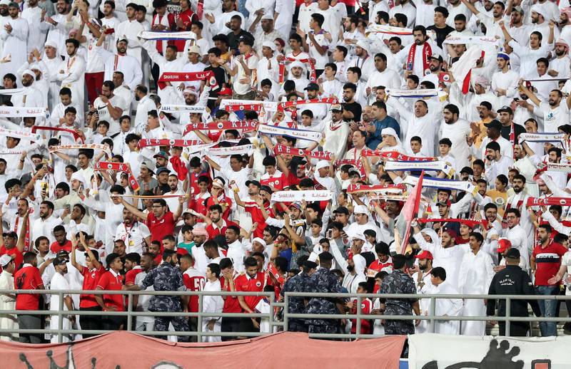 Sharjah, United Arab Emirates - May 15, 2019: Football. Sharjah fans celebrate winning the league after the game between Sharjah and Al Wahda in the Arabian Gulf League. Wednesday the 15th of May 2019. Sharjah Football club, Sharjah. Chris Whiteoak / The National
