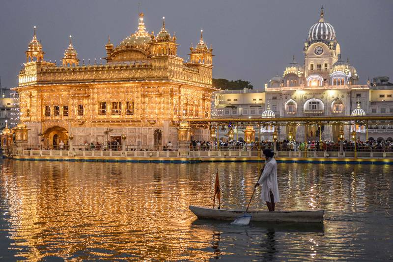 A Sikh rows a boat at the sacred pool of Amritsar's Golden Temple on the anniversary of the birth of Guru Angad Dev Ji, the second guru of Sikhs. AFP