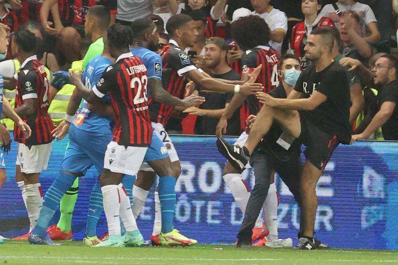 Fans try to invade the pitch during the match between Nice and Marseille. AFP