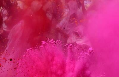 The festival is marked by raucous parties where people throw and smear coloured powder on each other. EPA