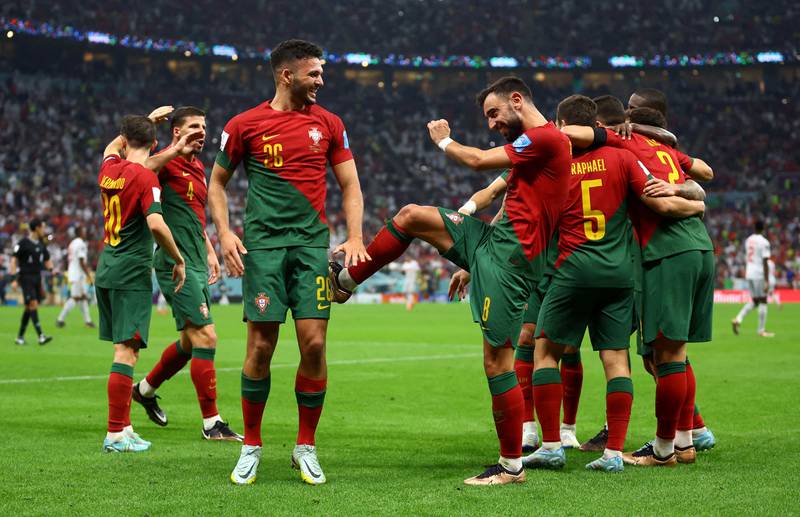 Portugal's Raphael Guerreiro celebrates scoring their fourth goal with Bruno Fernandes. Reuters