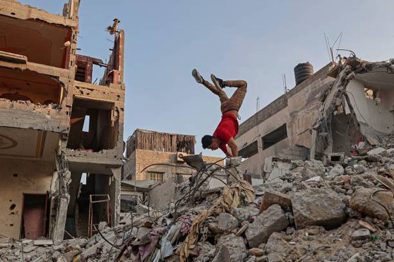 Palestinian youths practise parkour amid the rubble of buildings destroyed by Israeli air strikes in the latest round of fighting between Israel and Palestinian militants, in Rafah in the southern Gaza Strip.