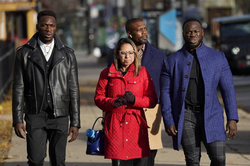 Attorney Gloria Schmidt Rodriguez, centre, walks with her clients Abimbola Osundairo, left, and Olabinjo Osundairo. The brothers claim Smollett paid them to stage the attack. AP