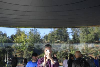 An attendee views an Apple iPhone before the event. Bloomberg