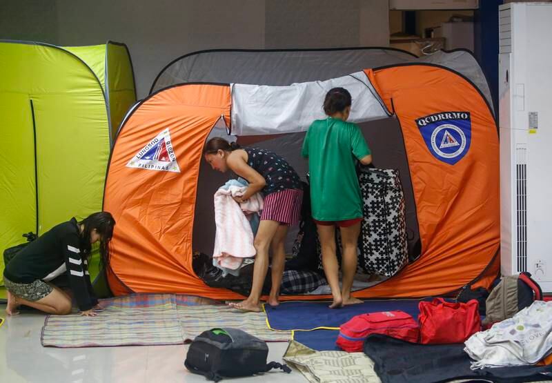 Residents arrive with their belongings at an evacuation centre in Quezon City, Metro Manila, Philippines, to shelter from Typhoon Nalgae. EPA