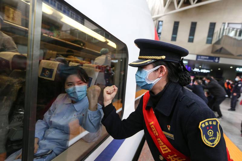 A train attendant gestures to medical staff leaving for Wuhan in Nanchang, China's central Jiangxi province. AFP