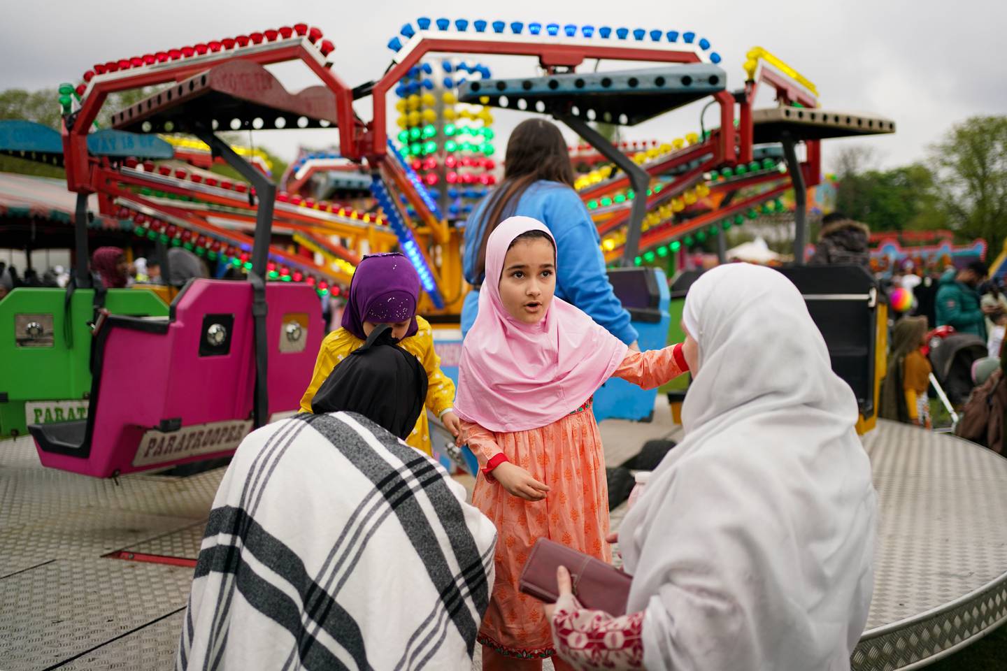 People enjoy theme park rides at a park in Birmingham, to celebrate Eid, on May 2.