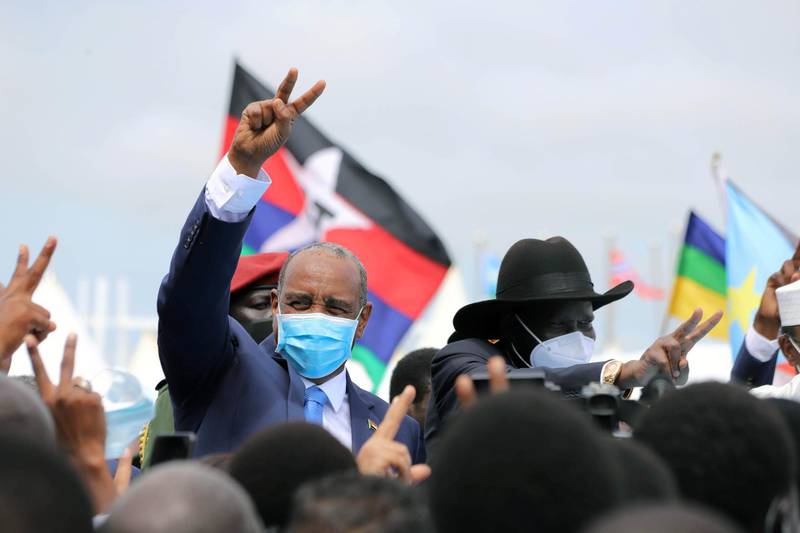 Sudan's Sovereign Council Chief General Abdel Fattah al-Burhan and South Sudan's President Salva Kiir, flash a two finger salute as they arrive for the signing of the peace agreement.  Reuters