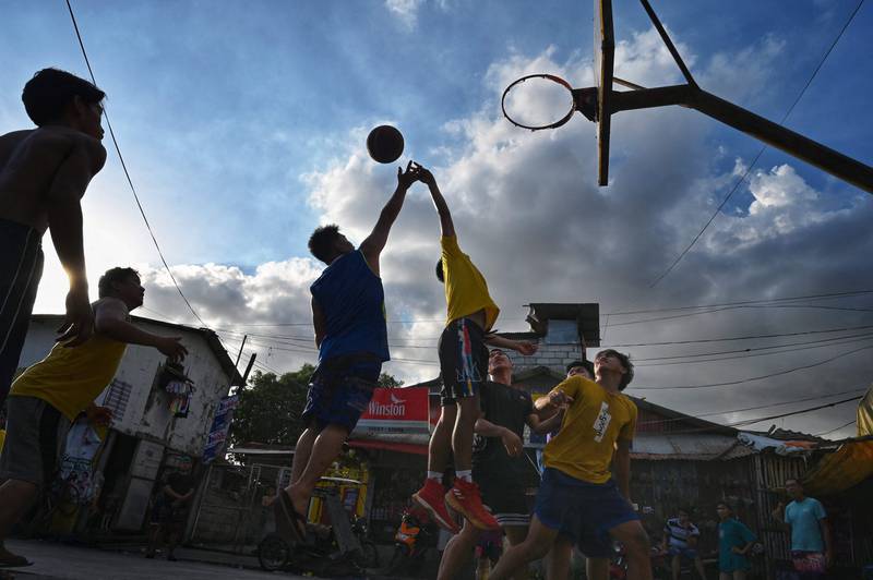 People playing basketball on a street in the Tondo district of Manila, Philippines. AFP