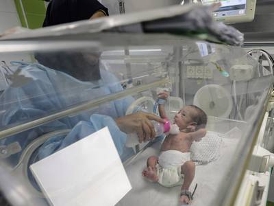 A four-day-old baby receives medical treatment in the nursery at Nasser Hospital in Khan Younis. EPA