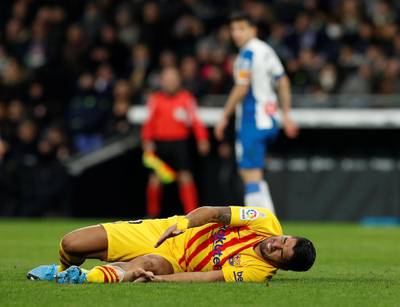 Barcelona's Luis Suarez reacts after sustaining an injury. Reuters