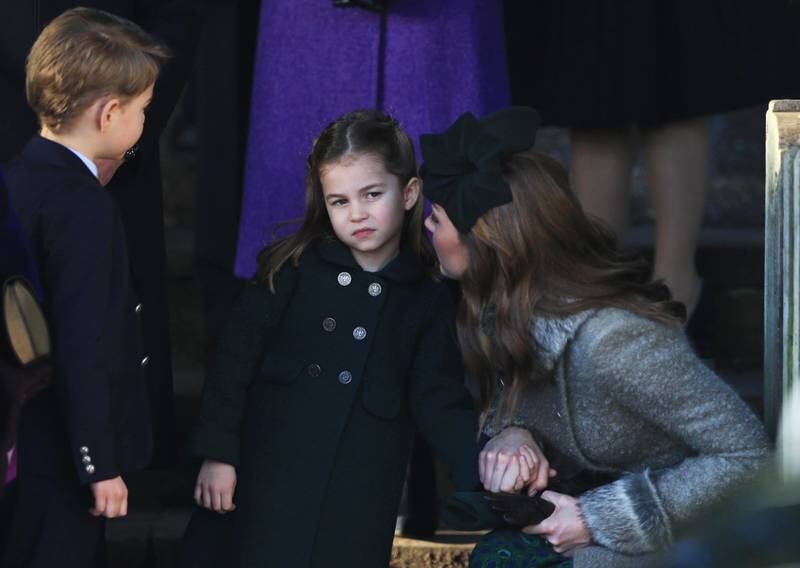 Kate speaks to Princess Charlotte as Prince George as they leave the Christmas Day service at the Church of St Mary Magdalene on the Sandringham estate in 2019.