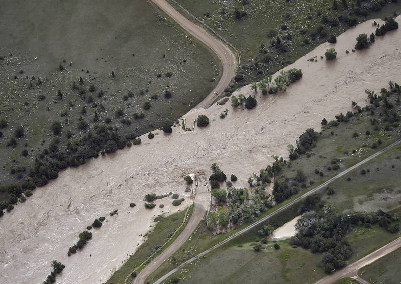 The bridge to Tom Miner Basin has been washed out as major flooding washed away roads and set off mudslides in Yellowstone National Park in Montana. The Billings Gazette / AP