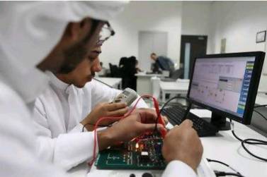 Students solder circuit boards at Abu Dhabi Polytechnic in Mohamed bin Zayed City Fatima Al Marzooqi / The National