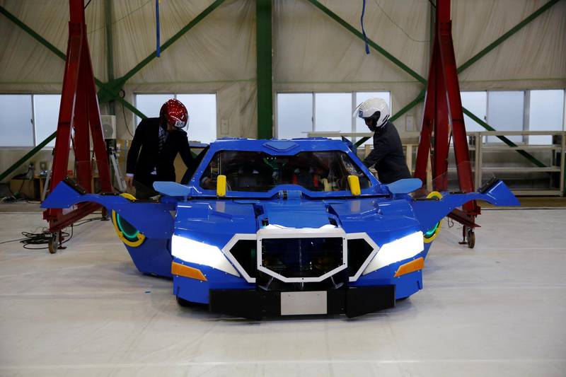 Passengers get into the "J-deite RIDE" that transforms itself from robot to car and vice-versa. All photos by Toru Hanai / Reuters