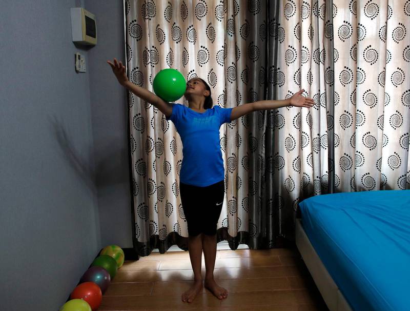 Thailand's rhythmic gymnastics athlete, Piyada Peeramatukorn, practices in her room during self isolation, Jintana Gymnastics Club, Bangkok, Thailand, April 16. Rungroj Yongrit / EPA