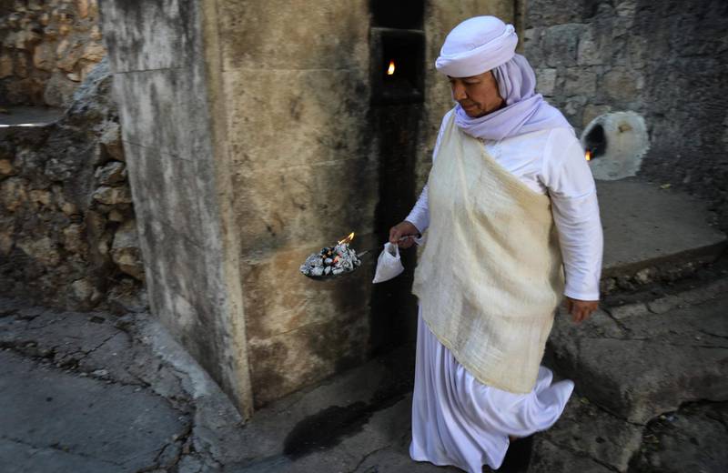 An Iraqi Yazidi woman visits the Temple of Lalish, in a valley near the Kurdish city of Dohuk about 430km northwest of the capital Baghdad, on July 16, 2019. AFP