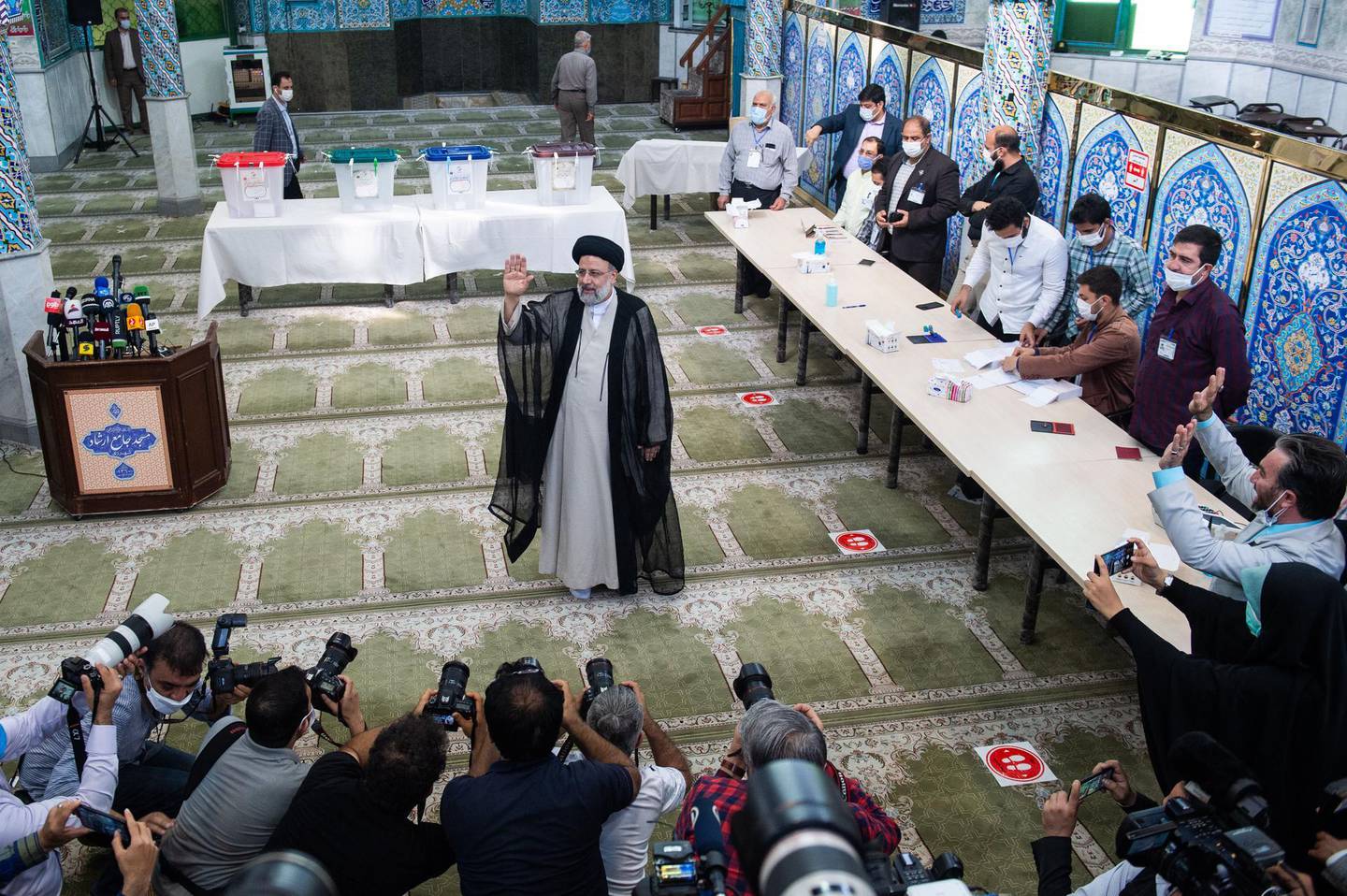 Ebrahim Raisi, judiciary chief, acknowledges the media after casting his vote in the Iranian presidential election in Tehran, Iran, on Friday, June 18, 2021. The stage-managed elevation of Raisi, 60, carries risks for the country’s guiding hand, Supreme Leader Ali Khamenei, given the ayatollah’s desire to quickly rid Iran of U.S. sanctions and a history of political unrest. Photographer: Ali Mohammadi/Bloomberg