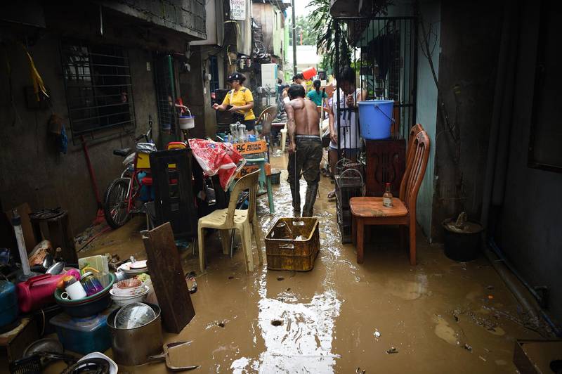 Residents clean their mud-filled homes after flooding brought about by Tropical storm Yagi. AFP