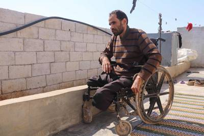Syrian Ibrahim al-Ali sits in his wheelchair at the Deir Hassan camp for the displaced in Idlib's northern countryside near the Turkish border. The 33-year-old father of four first lost three fingers, later his hearing in one ear. Then all at once, both legs and eyes. Ibrahim al-Ali was wounded every time he tried to escape Syria's war.  AFP