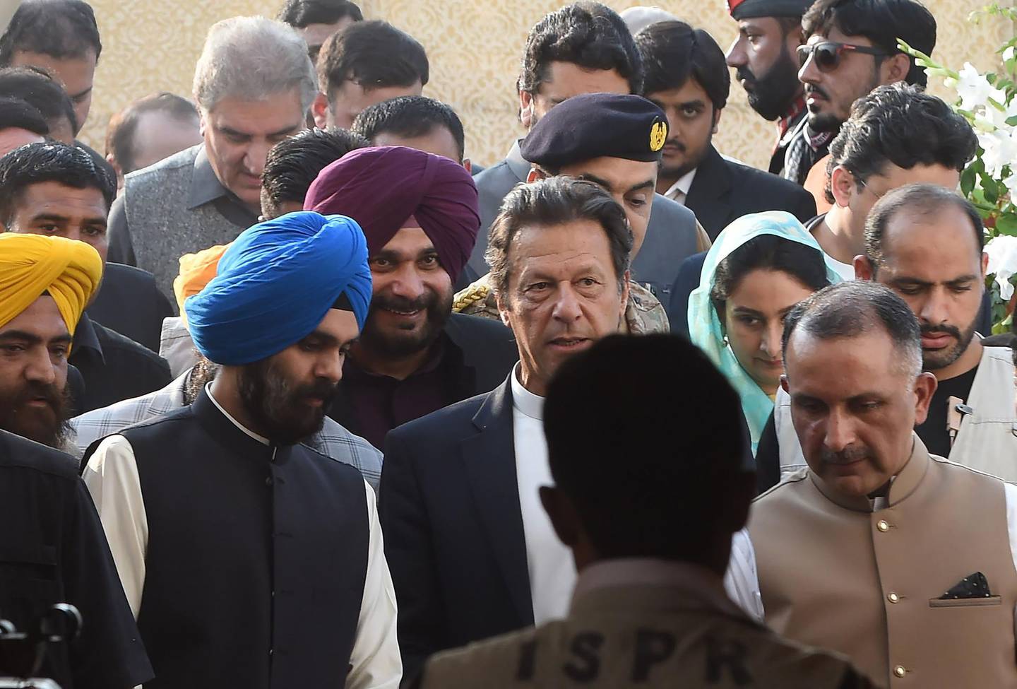 Pakistan Prime Minister Imran Khan (C) and alongside Indian Minister for Food Processing Industries Harsimrat Kaur Badal (2R) and India's Punjab cabinet minister and former cricketer Navjot Singh Sidhu (3L), arrive to attend the groundbreaking ceremony for the Kartarpur Corridor in Kartarpur on November 28, 2018. Pakistan Prime Minister Imran Khan launched the groundbreaking ceremony of the religious corridor between India and Pakistan. / AFP / ARIF ALI
