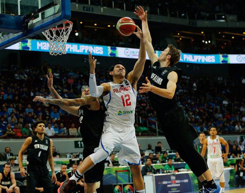 June Mar Fajardo (2-R) of the Philippines in action against Isaac Fotu (2-L) and Thomas Abercrombie (R) of New Zealand during the 2016 Fiba Olympic Qualifying tournament match between the Philippines and New Zealand at the SM Mall of Asia Arena in Pasay City, south of Manila, Philippines, 06 July 2016. Mark R Cristino / EPA