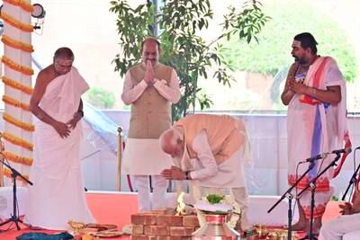 Mr Modi prays before the ceremony for the triangular $120 million building. AP