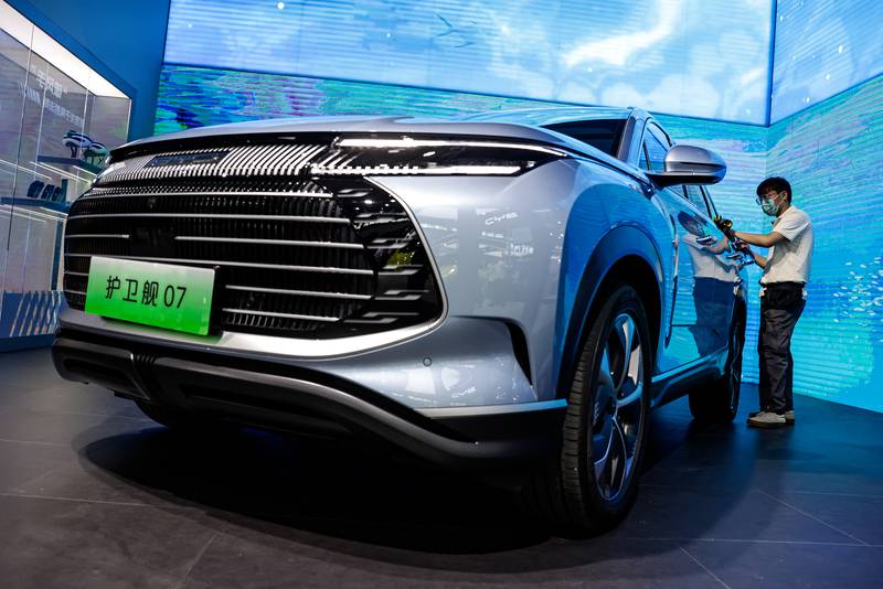 An employee cleans a BYD car during the 2023 Central China International Auto Show last month in Wuhan, China. Getty