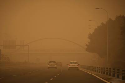 Cars drive in a cloud of red dust in Santa Cruz de Tenerife, Spain. AP Photo