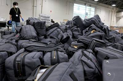 A worker prepares to take bags of ballots to be sorted and processed by the Los Angeles County Registrar. Keith Birmingham/The Orange County Register via AP