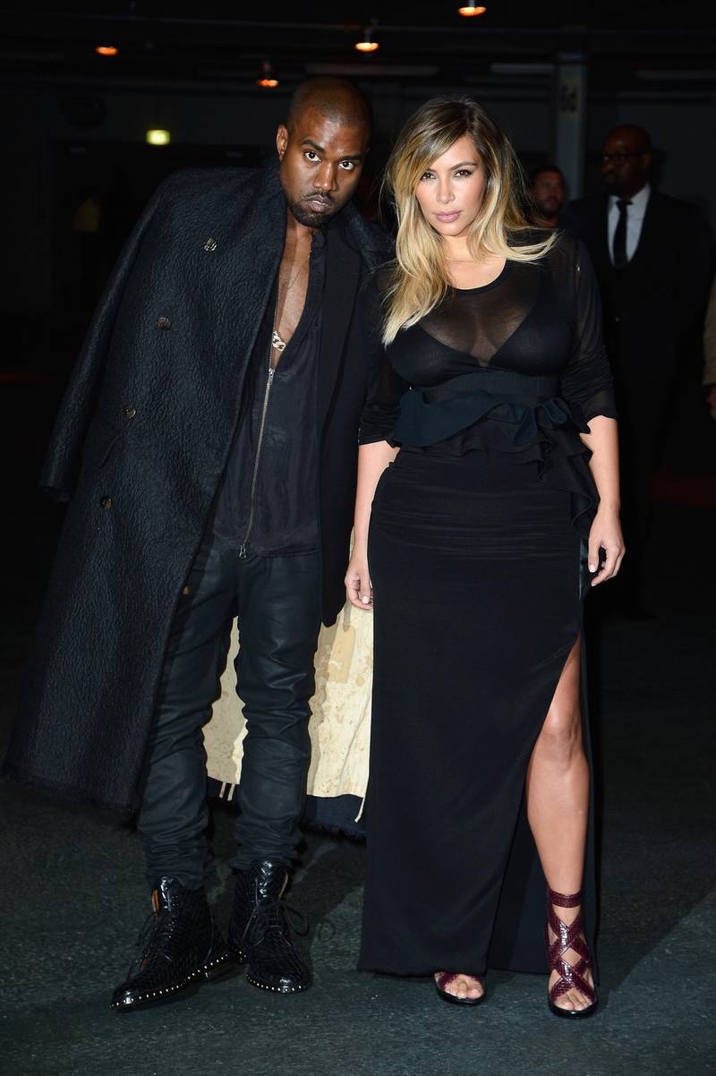 PARIS, FRANCE - SEPTEMBER 29:  Kim Kardashian and Kanye West attend the Givenchy show as part of the Paris Fashion Week Womenswear  Spring/Summer 2014 on September 29, 2013 in Paris, France.  (Photo by Pascal Le Segretain/Getty Images)