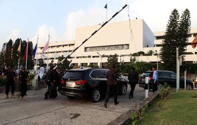 Security guards escort vehicles carrying parliamentarians of the National Assembly in Islamabad, Pakistan. EPA
