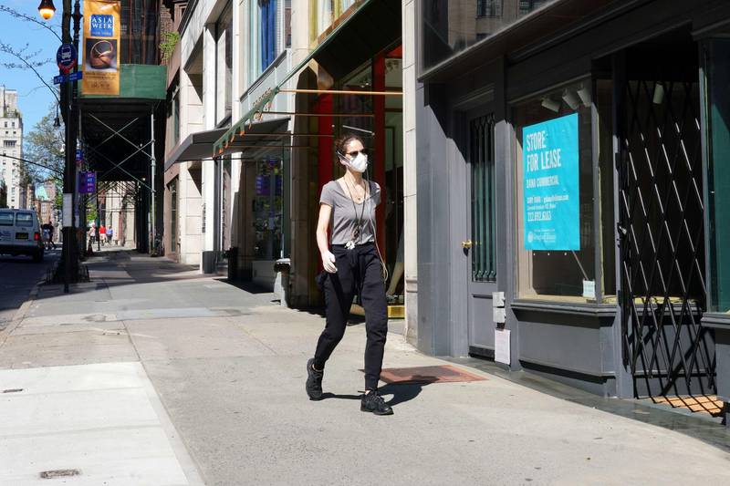 A woman walks while wearing a protective mask during the coronavirus pandemic in New York City. Covid-19 has spread to most countries around the world, claiming over 248,000 lives with over 3.5 million infections reported. Getty