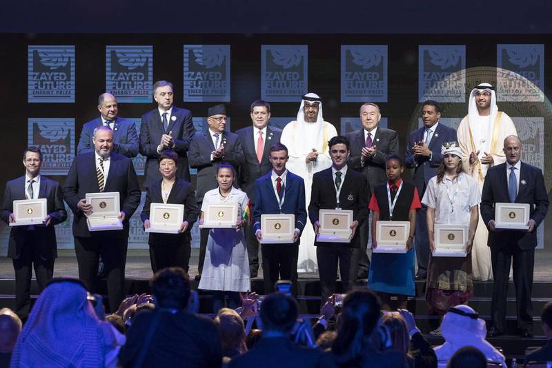 Dignitaries including Sheikh Mohammed bin Zayed, Crown Prince of Abu Dhabi and Deputy Supreme Commander of the Armed Forces, and Dr Sultan Al Jaber, UAE Minister of State and Adnoc Group chief executive, stands with last year's winners of the Zayed Future Energy Prize. Ryan Carter / Crown Prince Court - Abu Dhabi