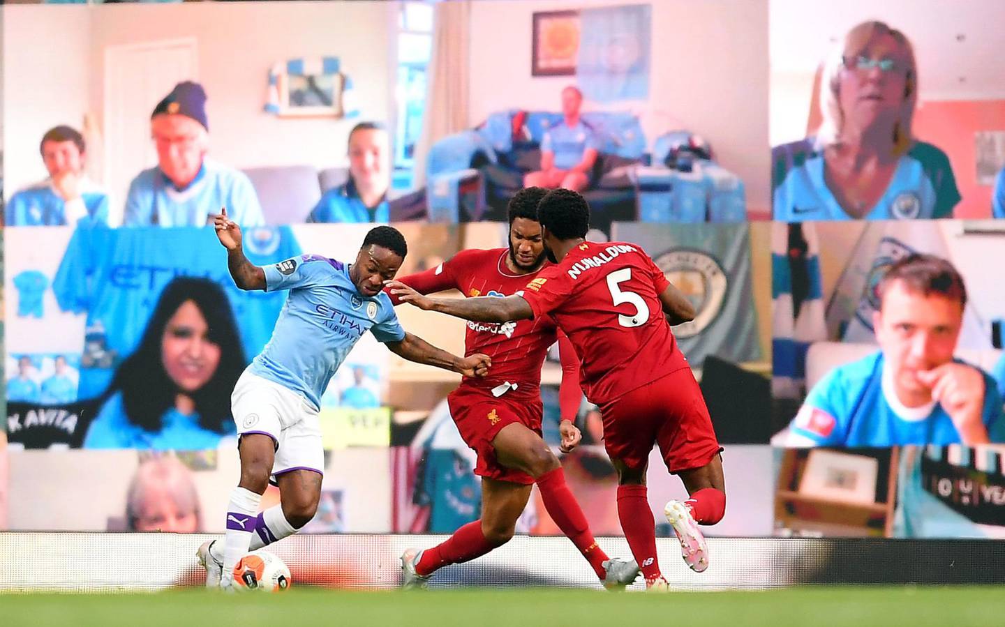 File photo dated 02-07-2020 of Liverpool's Joe Gomez concedes a penalty after holding back Manchester City's Raheem Sterling during the Premier League match at the Etihad Stadium, Manchester. PA Photo. Issue date: Thursday December 17, 2020. TV companies did their best to make up for the lack of atmosphere in empty stadiums and arenas by piping in crowd noise for the viewer. Manchester City also had a bank of screens behind one of the goals showing live fan reaction. But in a year when face coverings were prevalent, the gimmicks could not mask the cold truth that sport is a soulless affair without fans. See PA story SPORT Christmas 10 Things.  Photo credit should read Laurence Griffiths/NMC Pool/PA Wire.