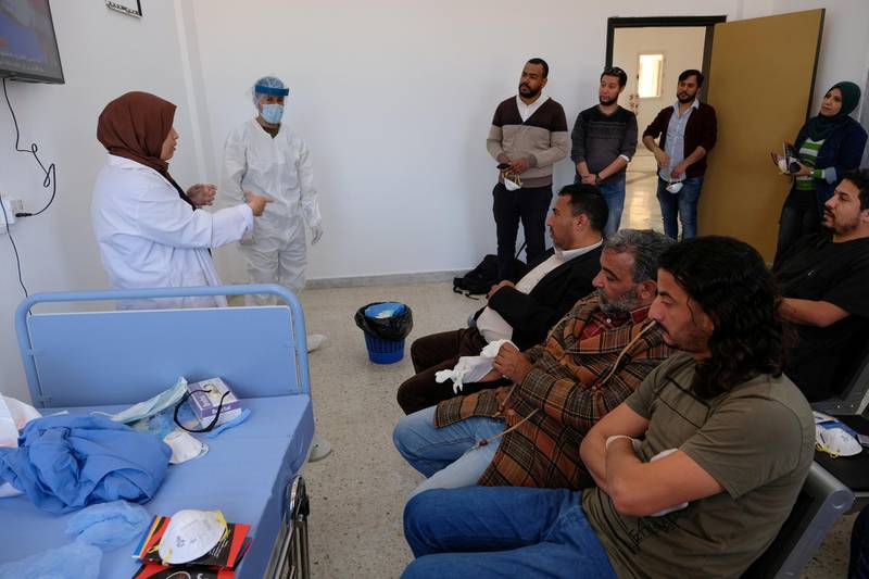 A doctor talks to nursing staff about sterilisation and handling suspected cases of coronavirus at a medical clinic in Benghazi, Libya. Reuters