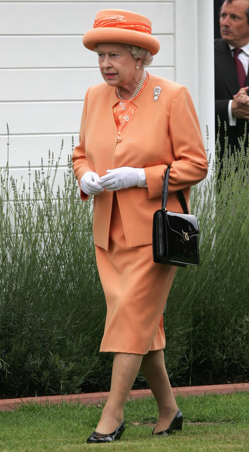 Queen Elizabeth ll, wearing orange, attends The Vivari Queen's Cup Final at Guards Polo Club on June 17, 2007, in Windsor, England. Getty Images