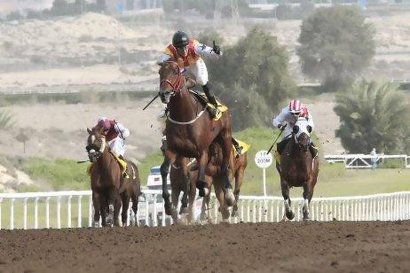 With jockey Wayne Smith aboard, Treble Jig, front, cruises to victory at the Jebel Ali Stakes in Race 3 on Friday.