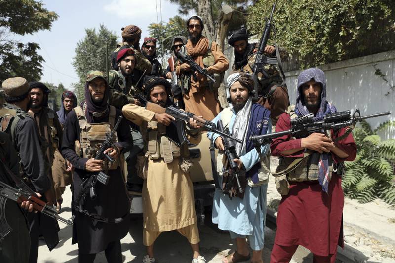 Taliban fighters pose for a photograph in Kabul on August 19. AP