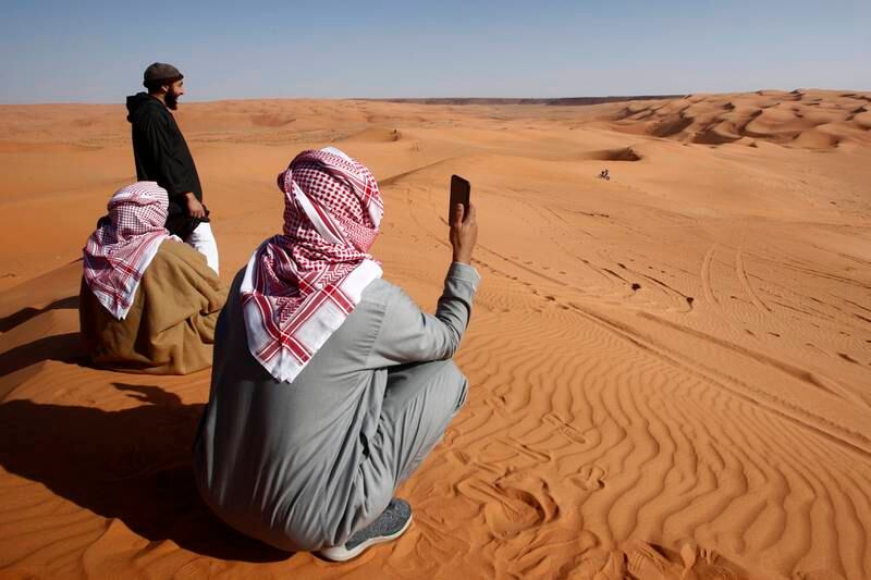 Saudi Arabian spectators watch stage 7 of the Rally Dakar 2022 near Riyadh. EPA