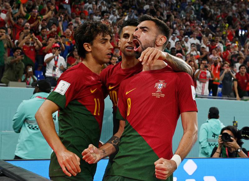 Joao Felix celebrates scoring Portugal's second goal with teammates Joao Cancelo and Bruno Fernandes. Reuters