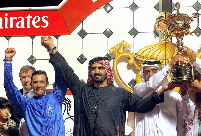 Jockey Frankie Dettori (L), Sheikh Mohamed Bin Rashed Al-Maktoum, UAE Minister of Defence and Crown Prince of Dubai and Sheikh Rashed Bin Maktoum (R) ruler of Dubai, celebrate after winning Dubai's richest horse race 25 March 2000. Dubai Millennium, owned by the crown prince reached first to win 2.3 million dollars while the runner up won 1.2 million dollars and the third got 600,000 dollars.  (ELECTRONIC IMAGE) (Photo by RABIH MOGHRABI / AFP)